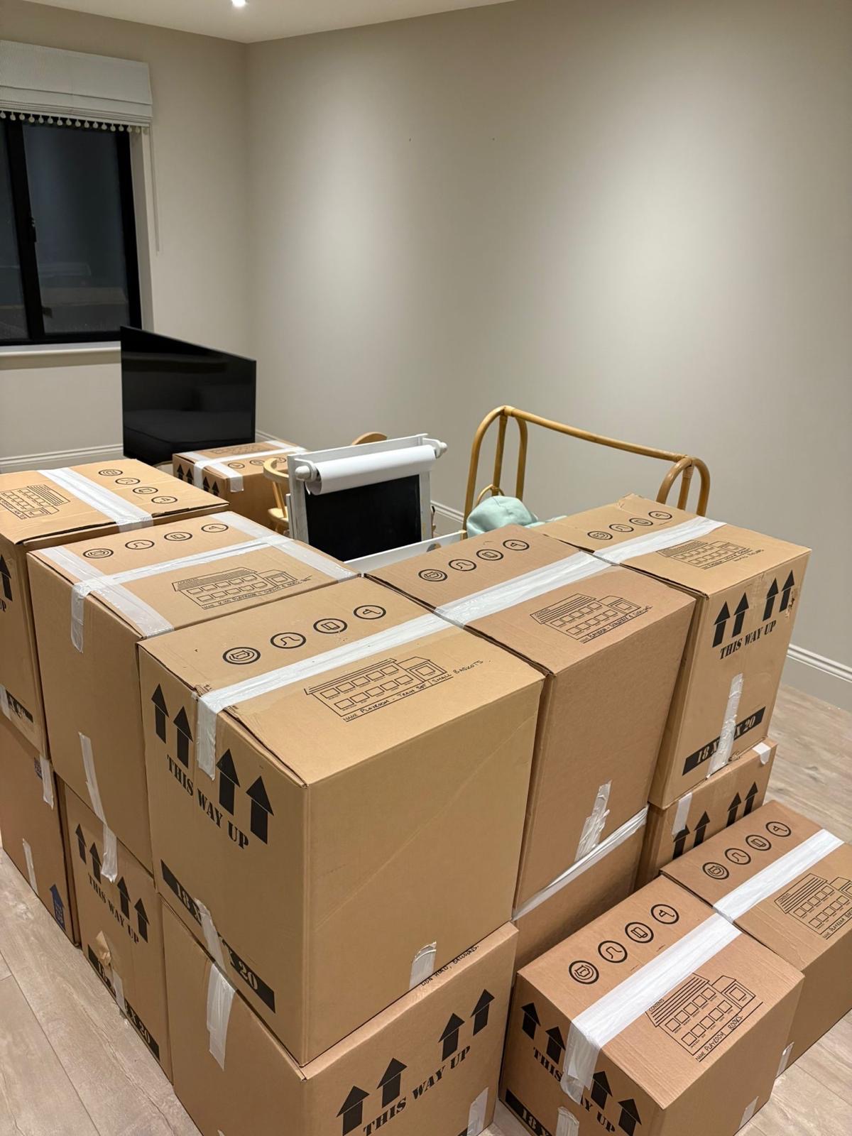 Packed cardboard moving boxes ready in a UK home